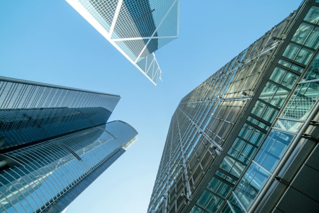 Modern skyscrapers captured from below, showcasing Hong Kong's urban architecture.